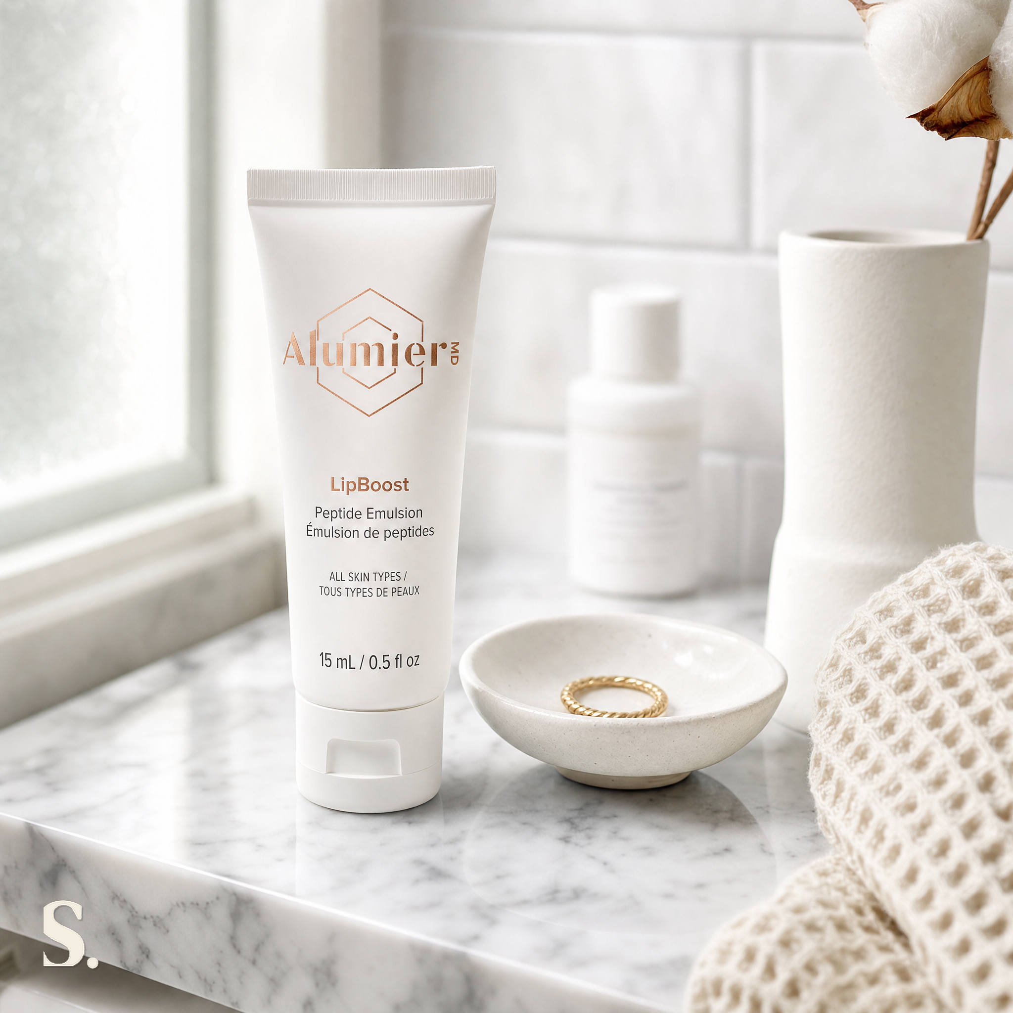 AlumierMD LipBoost in a lifestyle bathroom setting — Skintique review