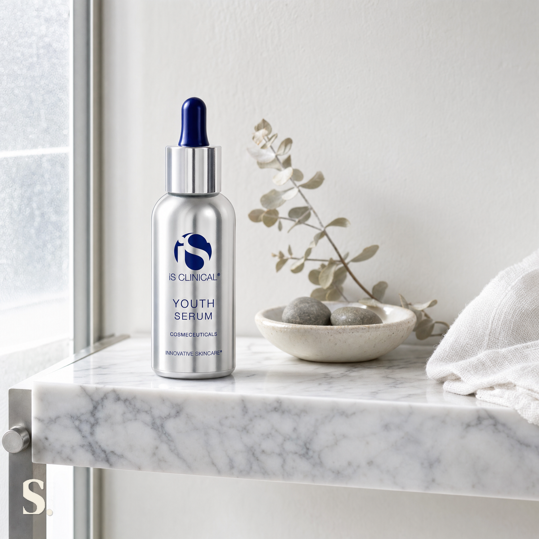 iS Clinical Youth Serum in a lifestyle bathroom setting — Skintique review